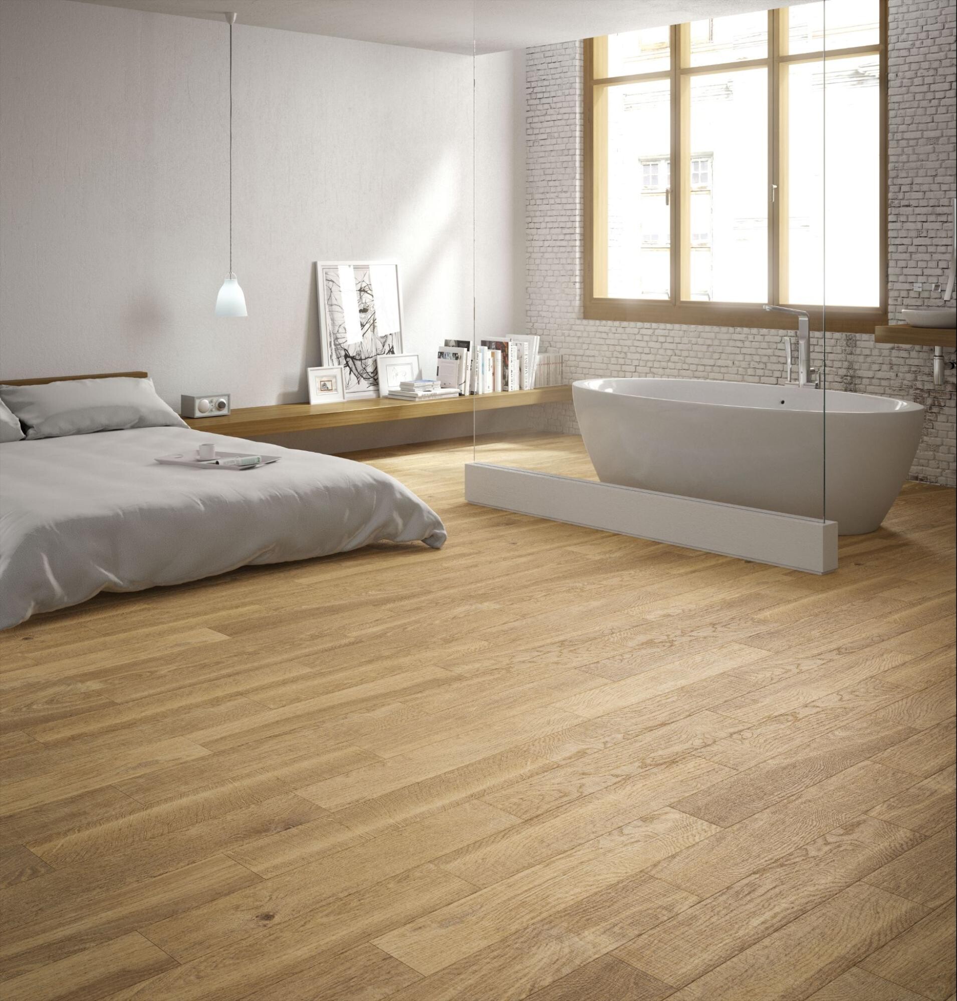 Dormitorio luminoso con suelo porcel&aacute;nico efecto madera clara